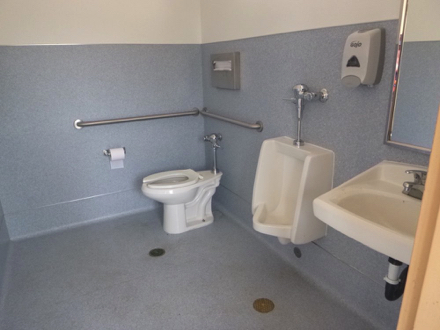 Accessible unisex restroom at the top of road from launch – hard surface – sink, toilet, grab bars